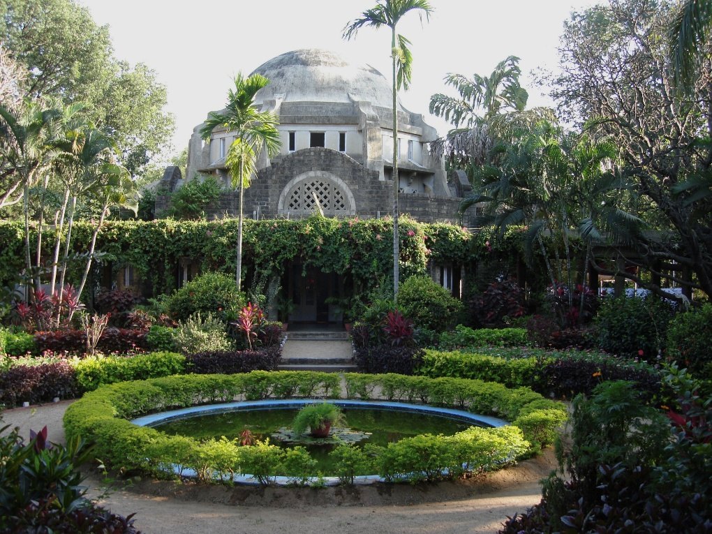 The Christian Medical College campus at Vellore: a domed building behind formal gardens and a lily pond.