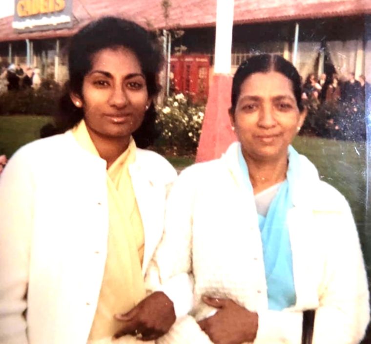 Grace as a young woman standing beside her mother.