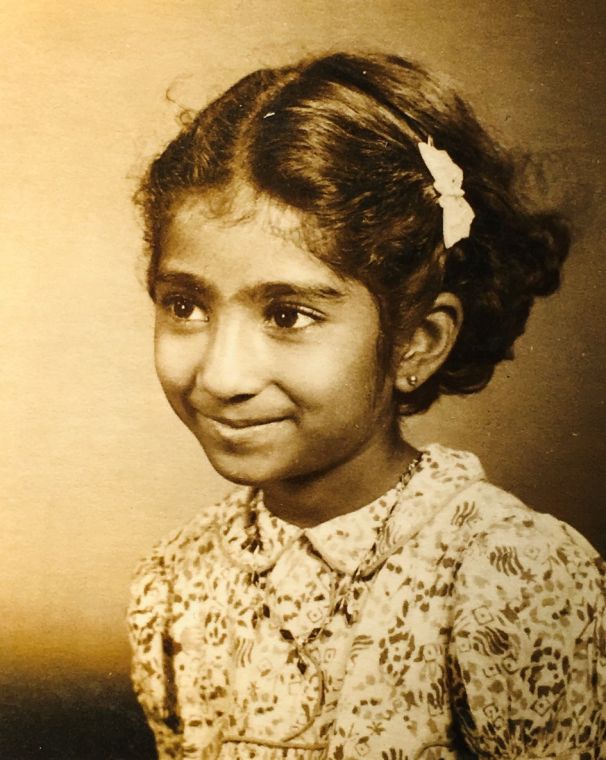 A sepia studio portrait of Grace as a young girl in India.